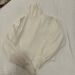 Good American cropped white turtle neck sweater